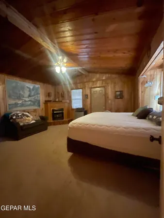 a large bed sitting in a room next to a lamp