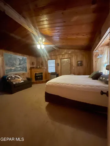 a large bed sitting in a room next to a lamp