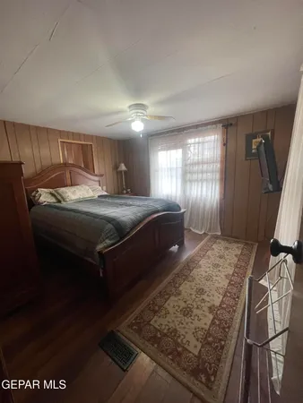 a room with a bed and a dresser
