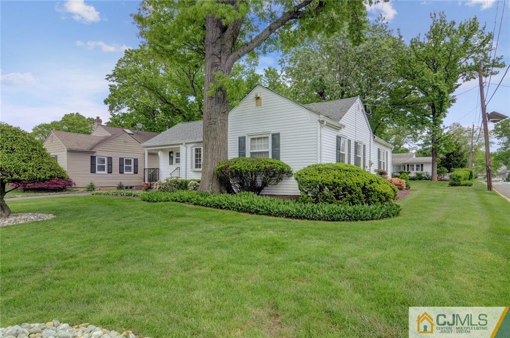 87 West Hill Road Colonia, NJ 07067 - Photo 2 of 18 a view of a house with a big yard potted plants and large tree
