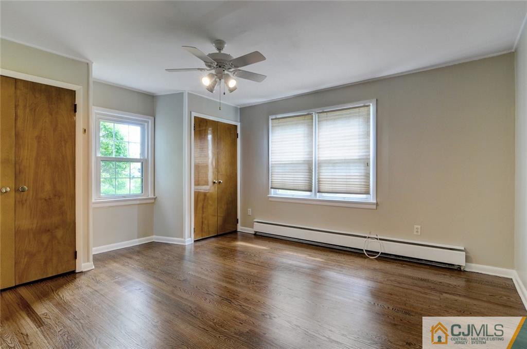 87 West Hill Road Colonia, NJ 07067 - Photo 12 of 18 a view of an empty room with window and wooden floor