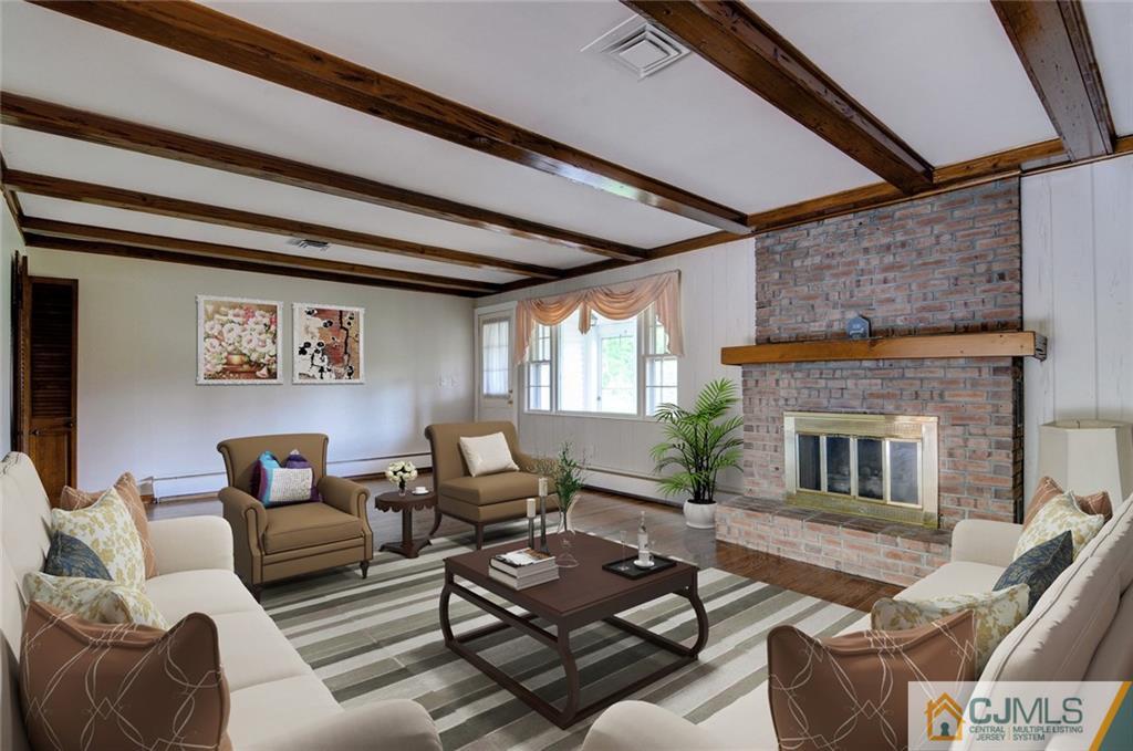 87 West Hill Road Colonia, NJ 07067 - Photo 17 of 18 a living room with furniture and a fireplace