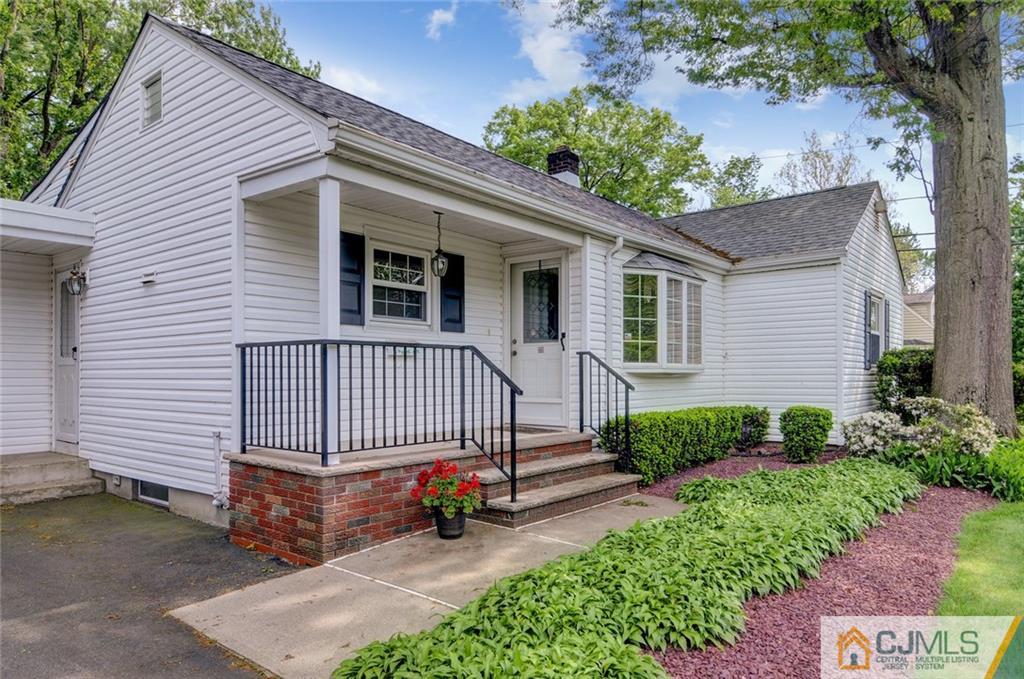 87 West Hill Road Colonia, NJ 07067 - Photo 3 of 18 a view of a house with a yard and potted plants