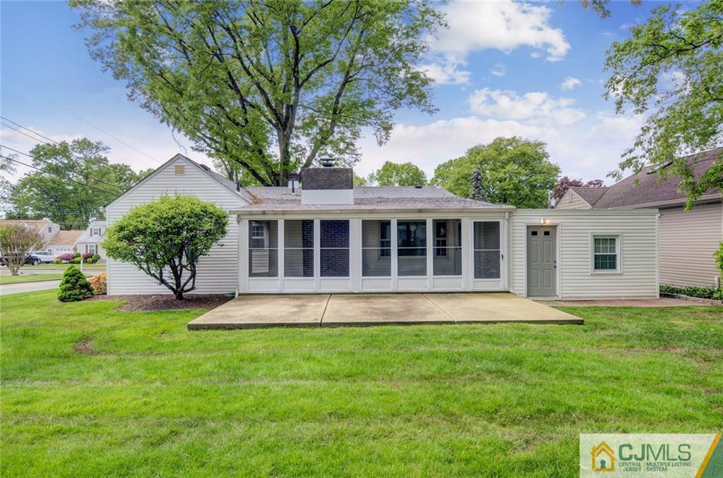 87 West Hill Road Colonia, NJ 07067 - Photo 4 of 18 a front view of a house with a yard and garage