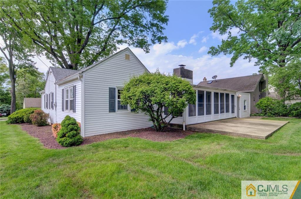 87 West Hill Road Colonia, NJ 07067 - Photo 5 of 18 a view of a house with a yard and a garden