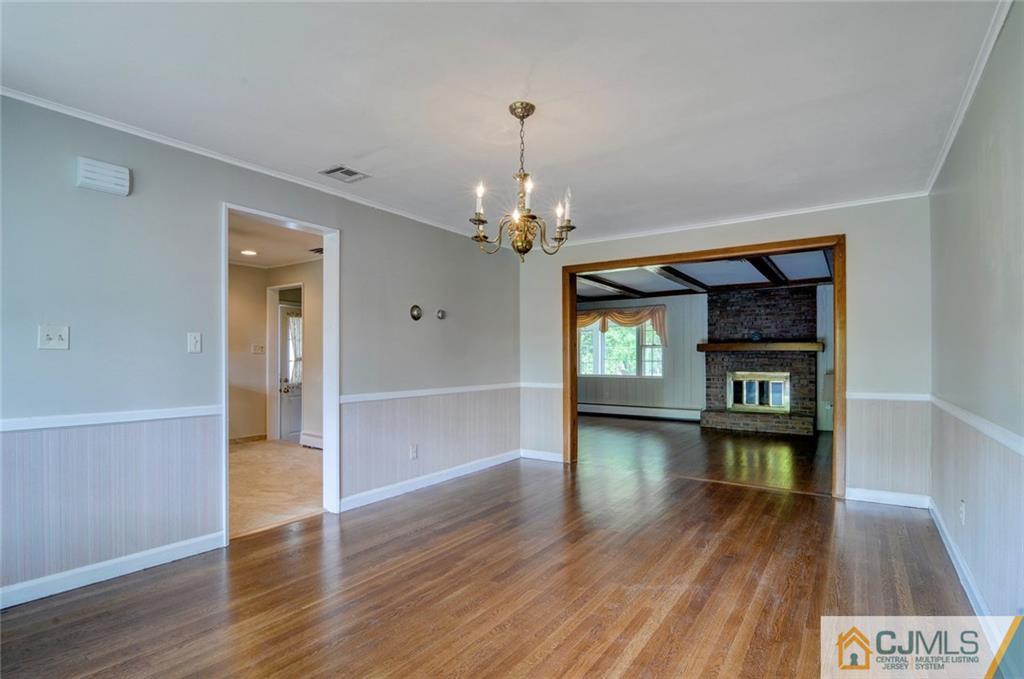 87 West Hill Road Colonia, NJ 07067 - Photo 7 of 18 a hallway with wooden floor chandelier and entryway