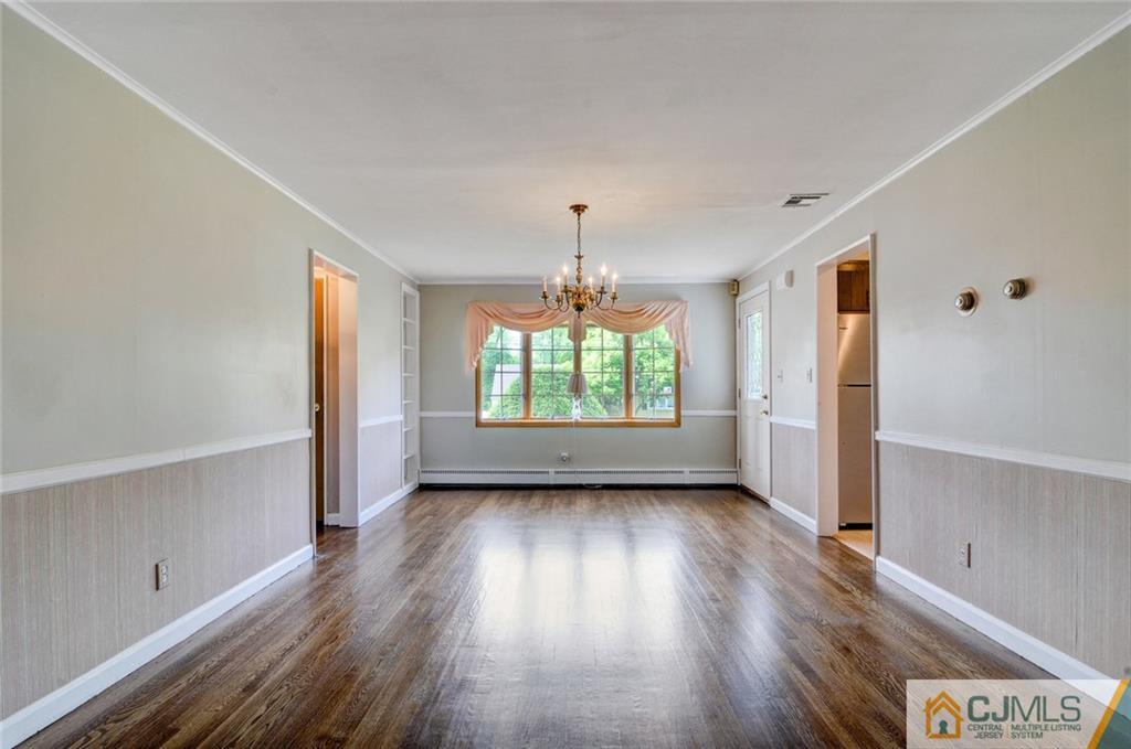 87 West Hill Road Colonia, NJ 07067 - Photo 8 of 18 wooden floor in an empty room with a window