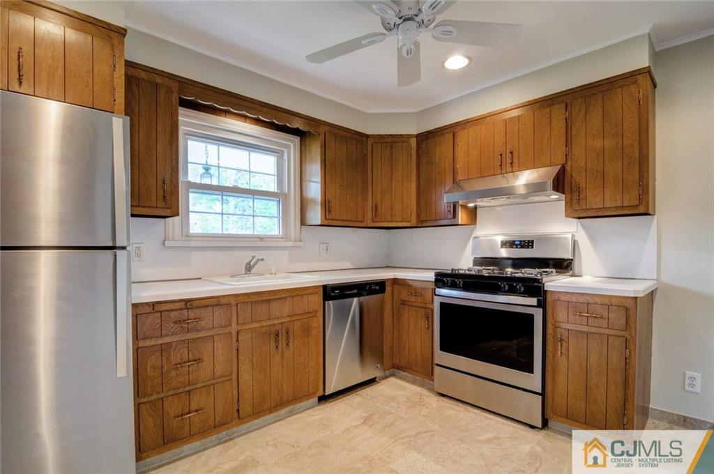 87 West Hill Road Colonia, NJ 07067 - Photo 9 of 18 a kitchen with stainless steel appliances granite countertop a stove a refrigerator and a sink