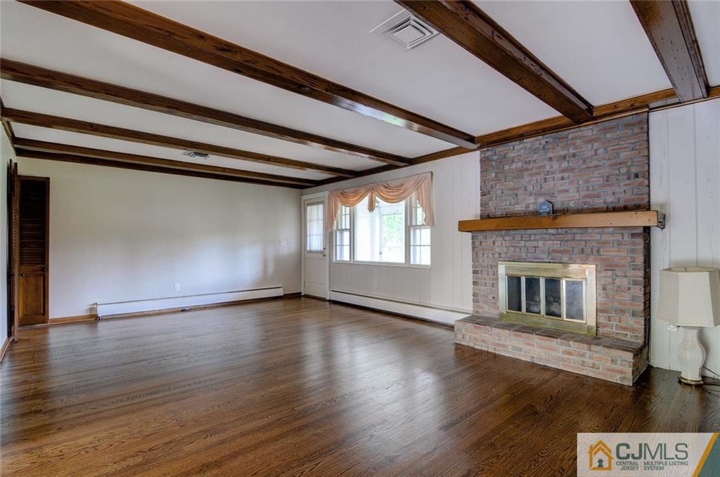 87 West Hill Road Colonia, NJ 07067 - Photo 10 of 18 a view of an empty room with wooden floor and a window