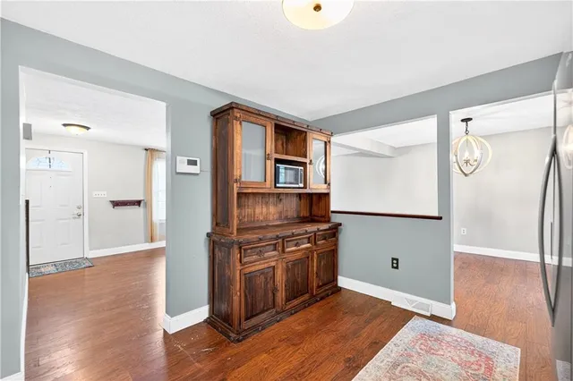 a kitchen with a refrigerator and a stove top oven