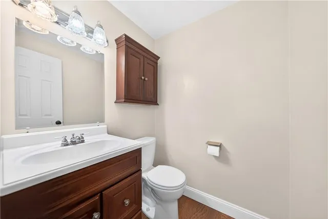 a bathroom with a sink vanity and a toilet