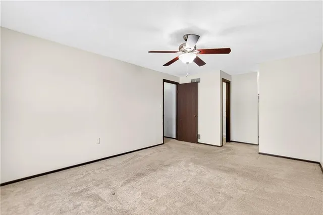 a view of room with a ceiling fan