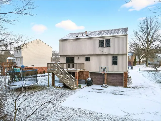 a view of a house with wooden fence