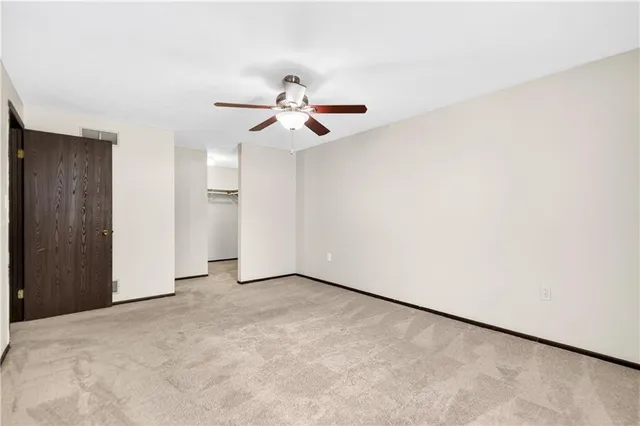 a view of room with a ceiling fan