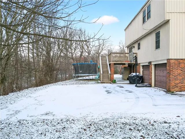 a view of a patio with a table chairs and a fire pit