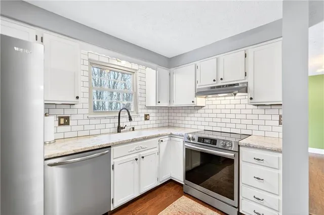 a kitchen with a sink stove and cabinets