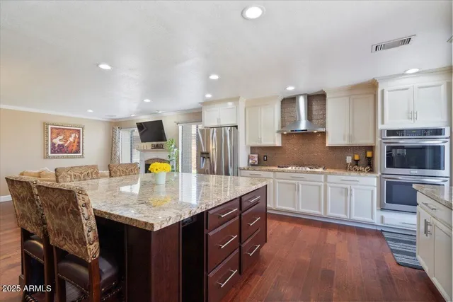 a view of a big room with wooden floor and windows