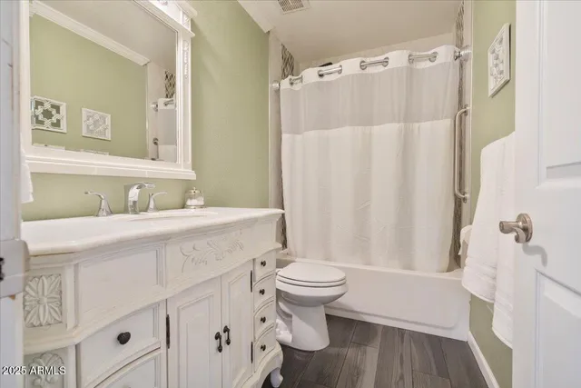 a kitchen with granite countertop a refrigerator and wooden cabinets