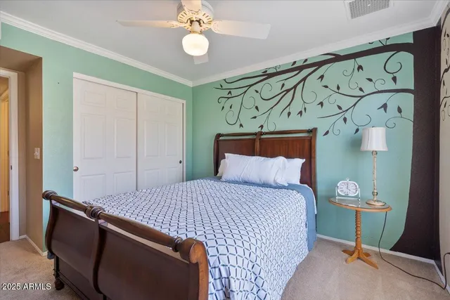 an empty room with wooden floor closet and windows