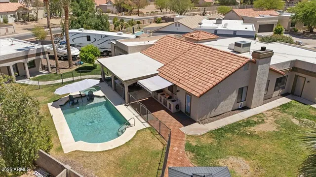 a kitchen with stainless steel appliances granite countertop a table chairs sink refrigerator and microwave