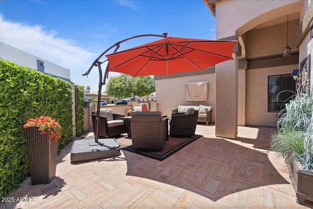 a view of a dining room with furniture a chandelier and wooden floor