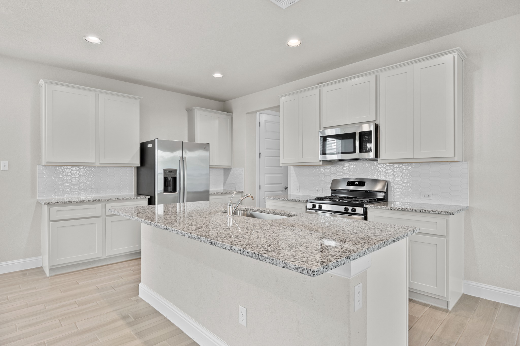213 Graver Street Georgetown, TX 78626 - Photo 3 of 33 A well-appointed kitchen features ample counter space, stainless appliances, and contemporary cabinetry.