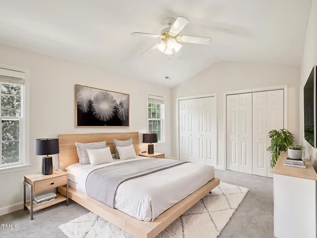 a bedroom with a large bed and a chandelier