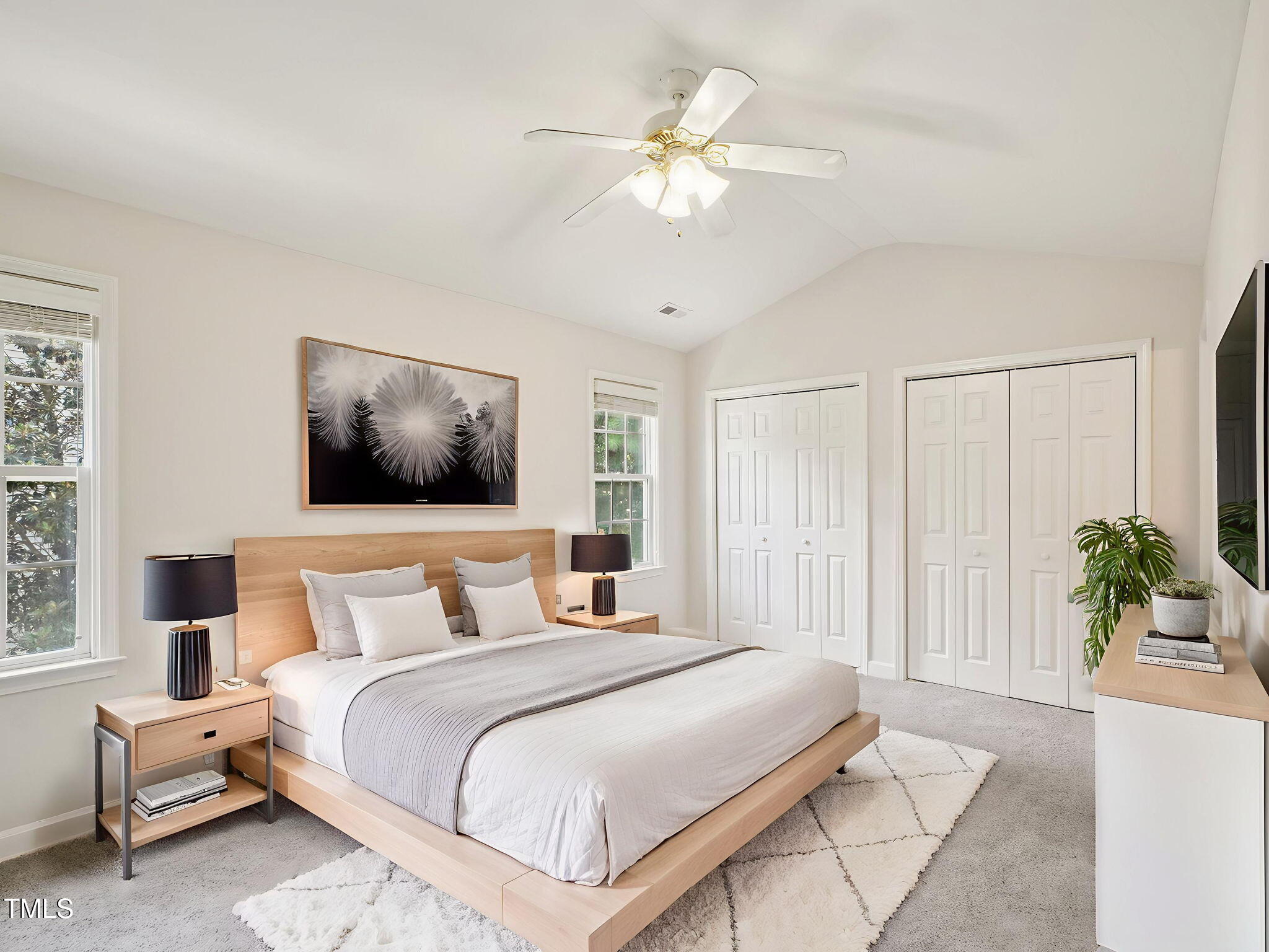 2228 Trailwood Valley Circle Raleigh, NC 27603 - Photo 11 of 19 a bedroom with a large bed and a chandelier