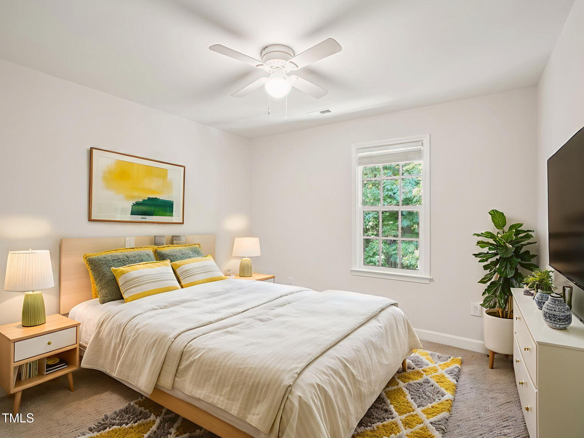 2228 Trailwood Valley Circle Raleigh, NC 27603 - Photo 14 of 19 a bedroom with a bed and a potted plant