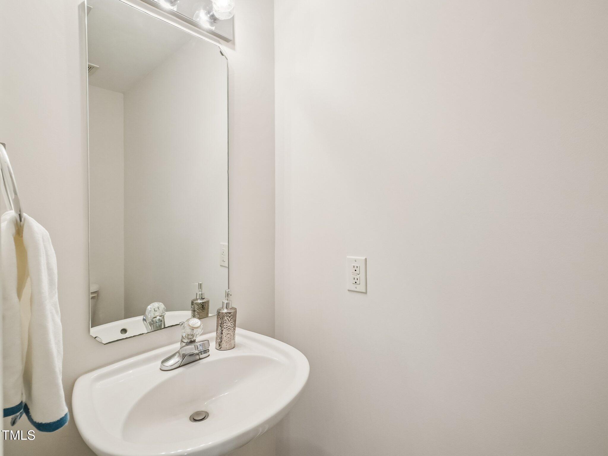 2228 Trailwood Valley Circle Raleigh, NC 27603 - Photo 10 of 19 a bathroom with a sink and a mirror
