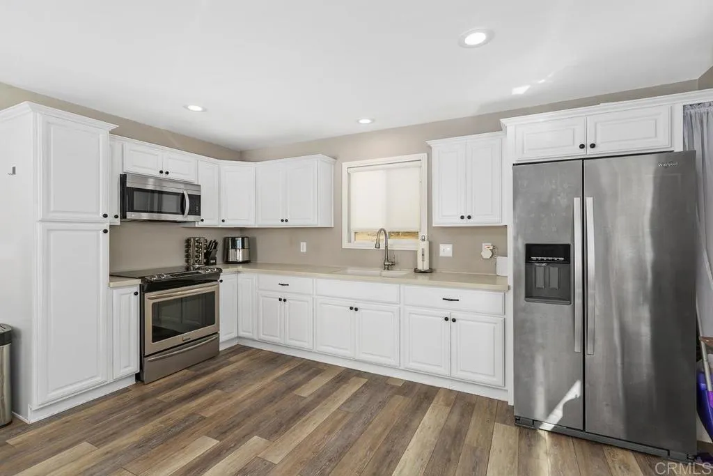 2625 Havencrest Drive Fallbrook, CA 92028 - Photo 26 of 35 a kitchen with granite countertop white cabinets and stainless steel appliances