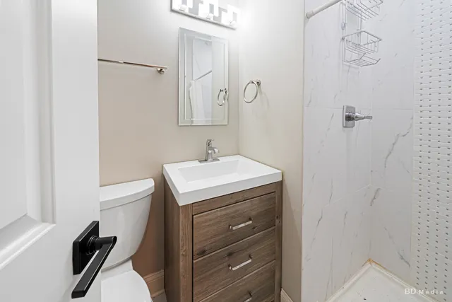 a bathroom with a sink a toilet and a mirror