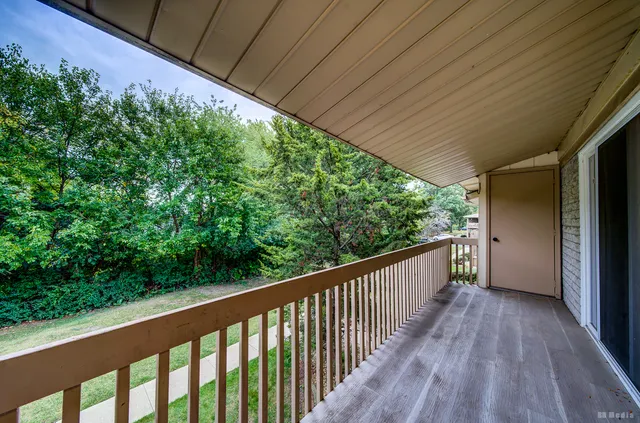 a view of balcony with wooden floor