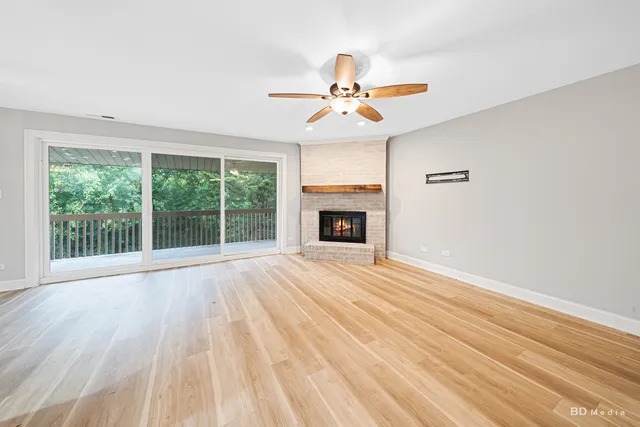 a view of empty room with fireplace and fan