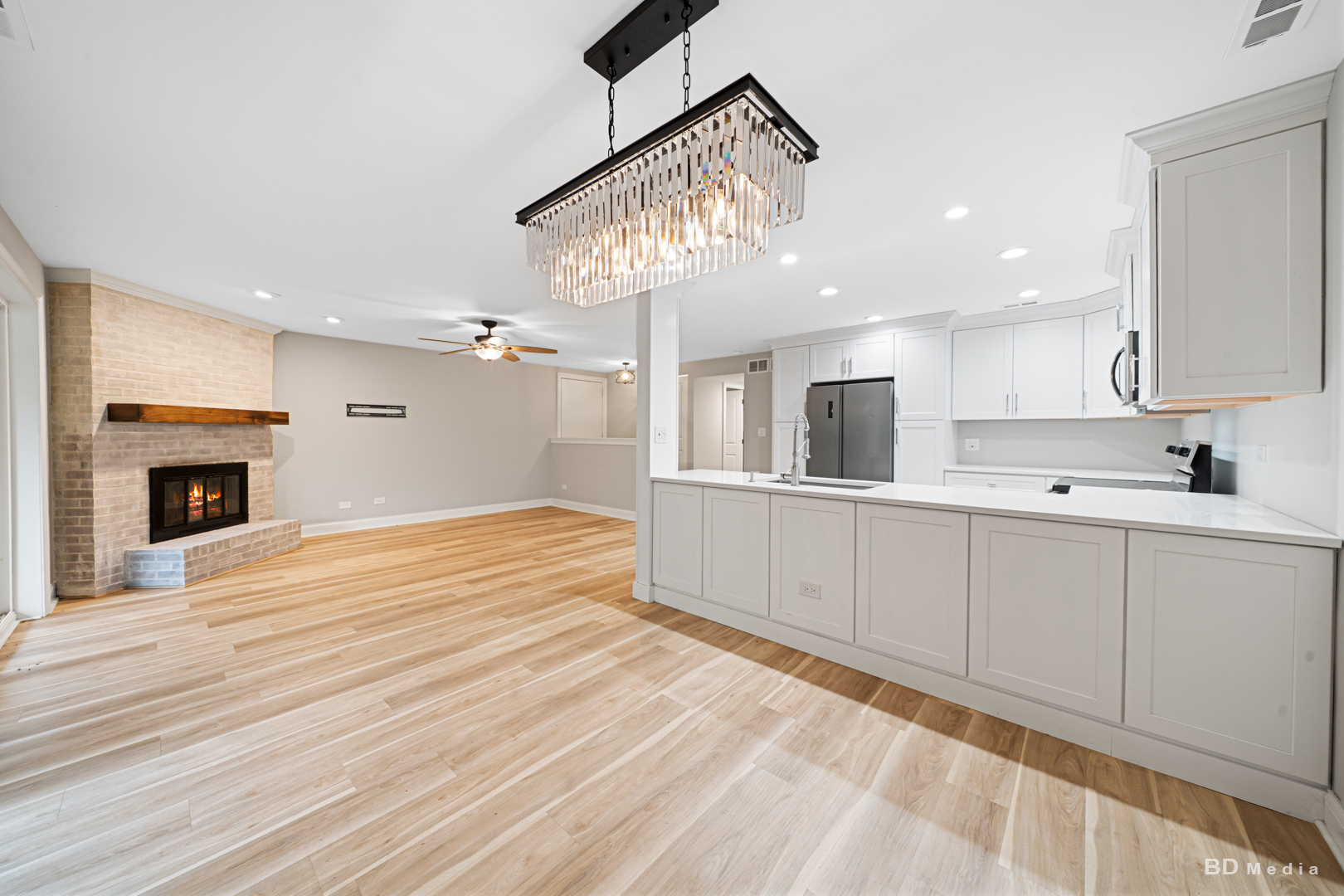 15717 Orlan Brook Drive, Unit G83 Orland Park, IL 60462 - Photo 10 of 21 a view of a kitchen with wooden floor and a fireplace