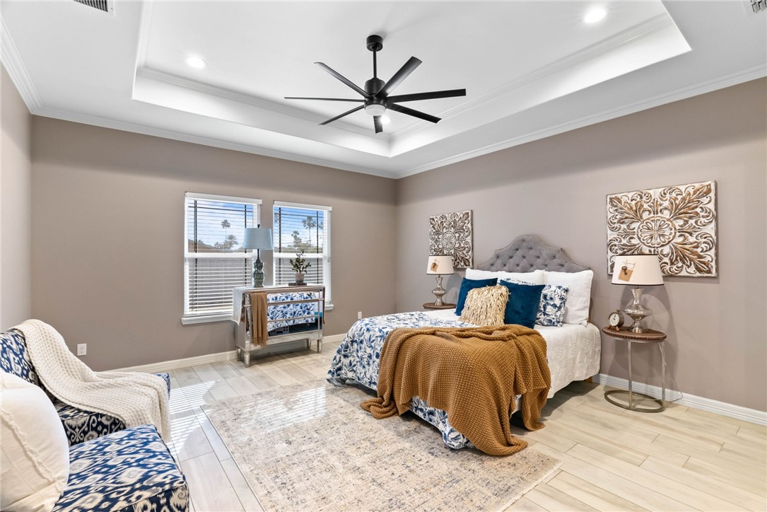 401 Big Shell Court Corpus Christi, TX 78418 - Photo 12 of 26 a bedroom with a bed and wooden floor