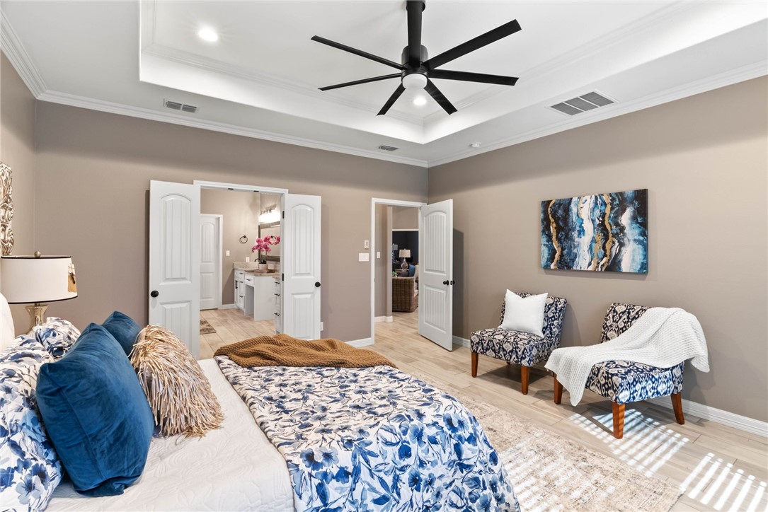 401 Big Shell Court Corpus Christi, TX 78418 - Photo 13 of 26 a bedroom with a bed and wooden floor