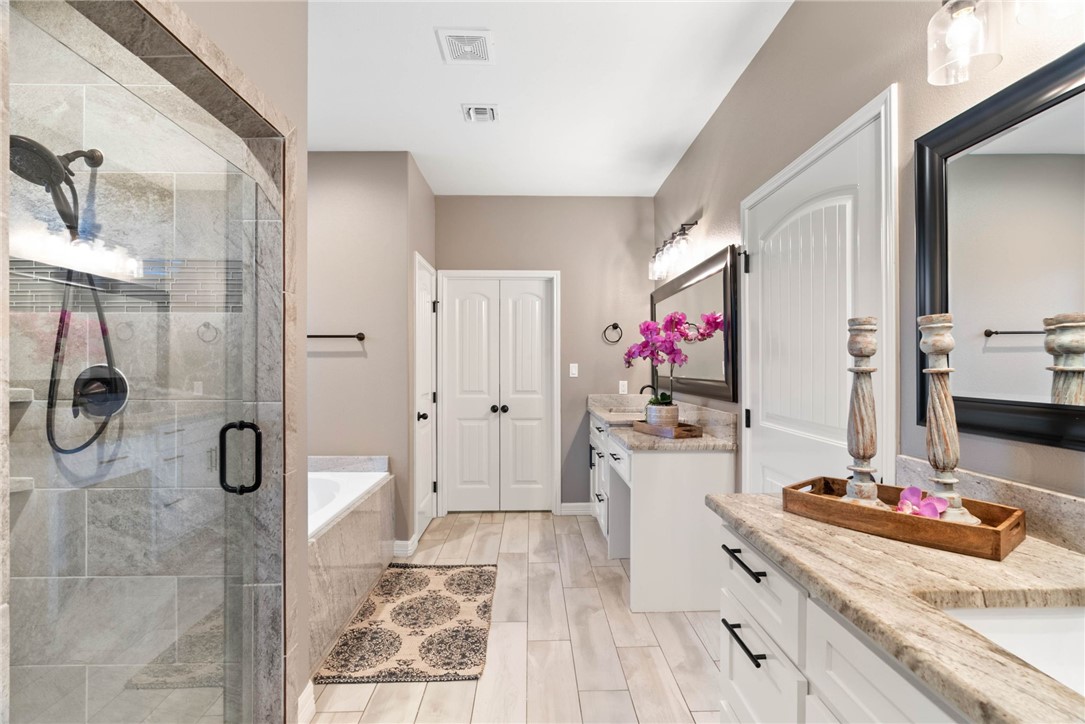 401 Big Shell Court Corpus Christi, TX 78418 - Photo 14 of 26 a bathroom with a tub sink and mirror