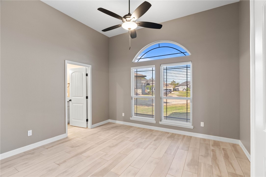 401 Big Shell Court Corpus Christi, TX 78418 - Photo 21 of 26 a view of an empty room with window and chandelier fan