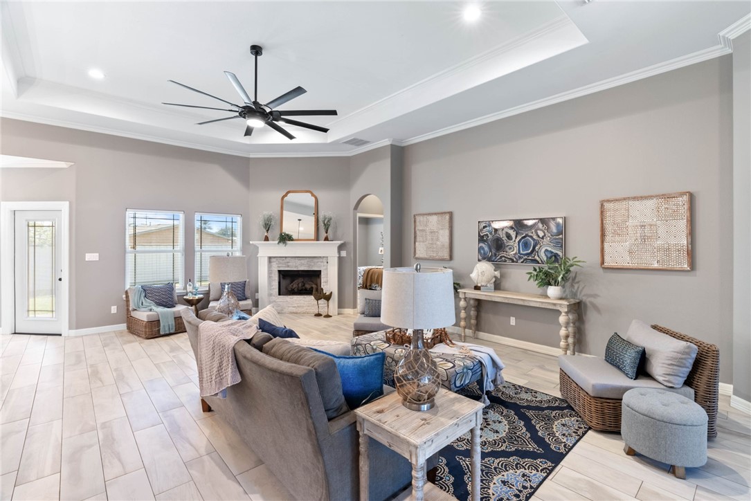 401 Big Shell Court Corpus Christi, TX 78418 - Photo 3 of 26 a living room with furniture a fireplace and a chandelier