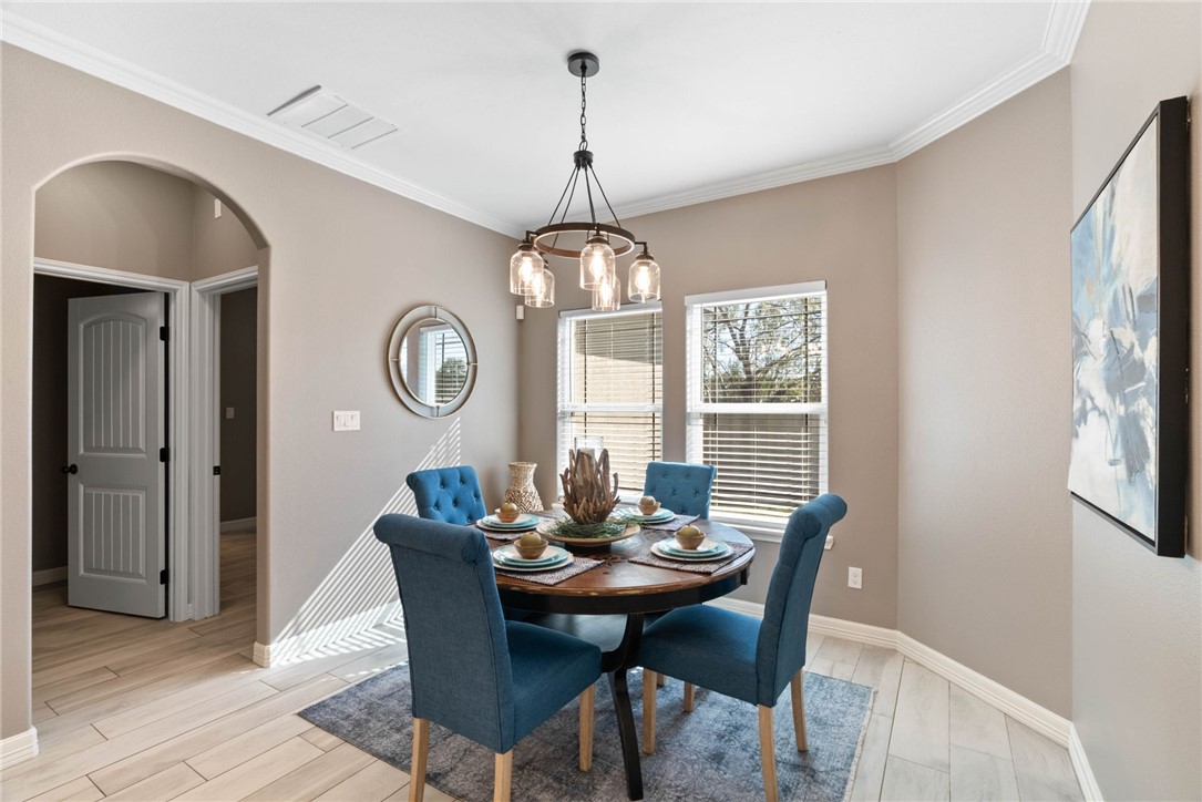 401 Big Shell Court Corpus Christi, TX 78418 - Photo 8 of 26 a dining room with furniture a rug and a large window