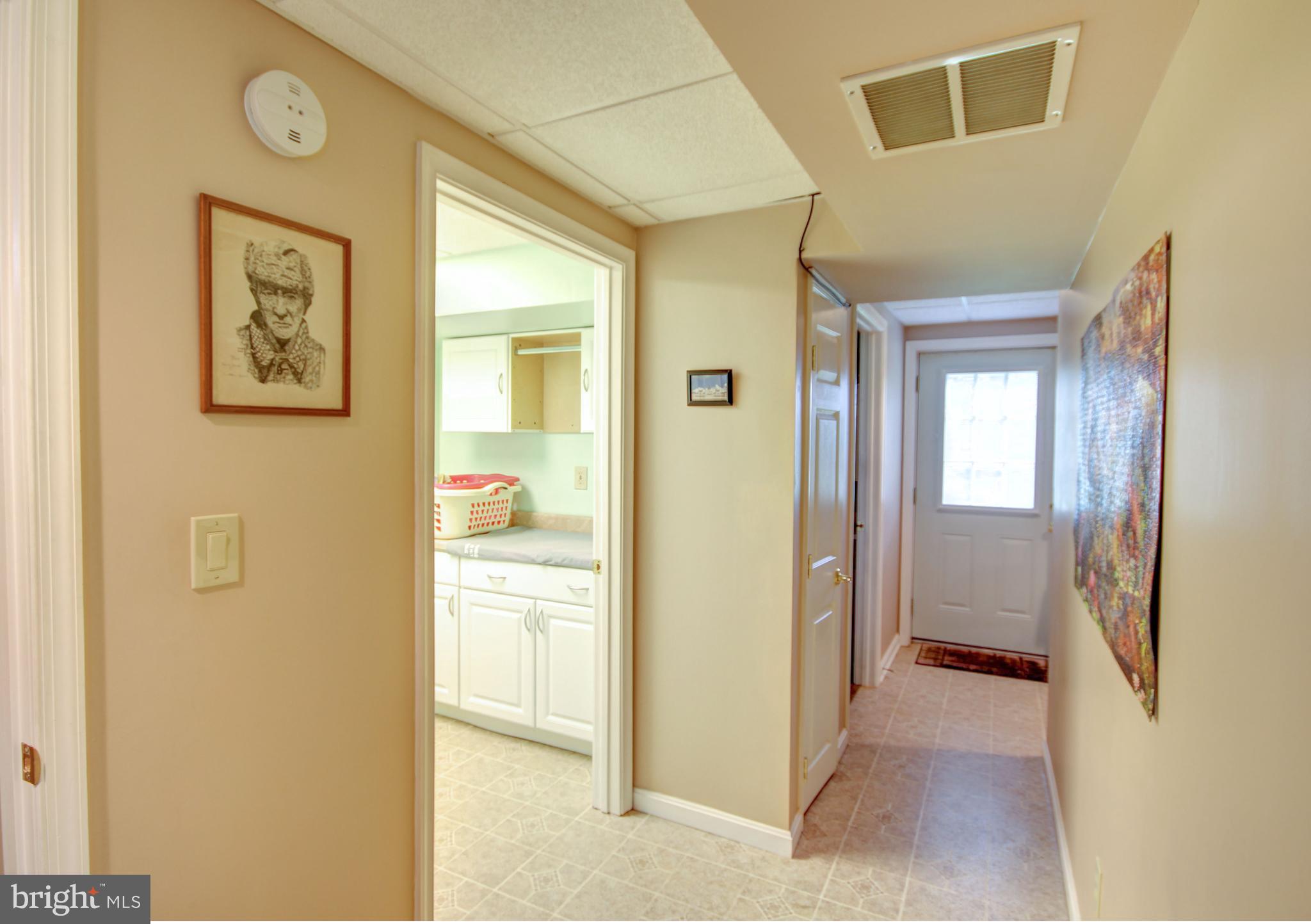 4364 Ridge Road Mount Airy, MD 21771 - Photo 22 of 39 a view of a hallway with wooden floor and a bathroom