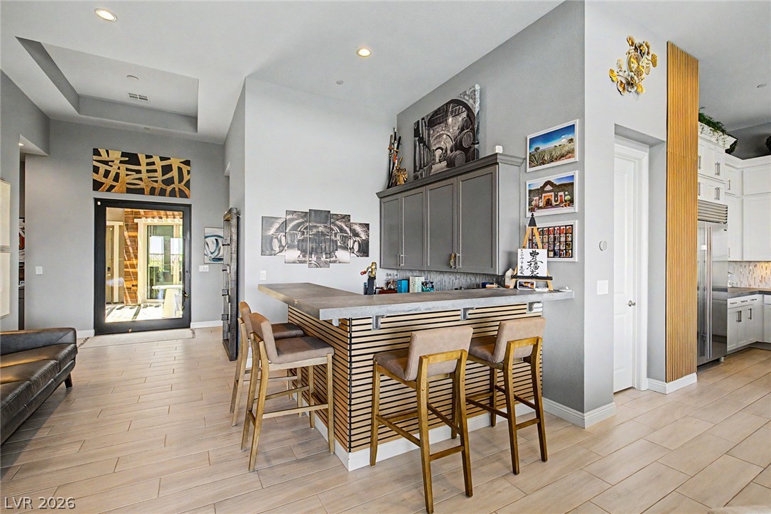 6014 Willow Ridge Court Las Vegas, NV 89135 - Photo 15 of 99 This living space features an elegant bar area, creating an inviting atmosphere for social gatherings.