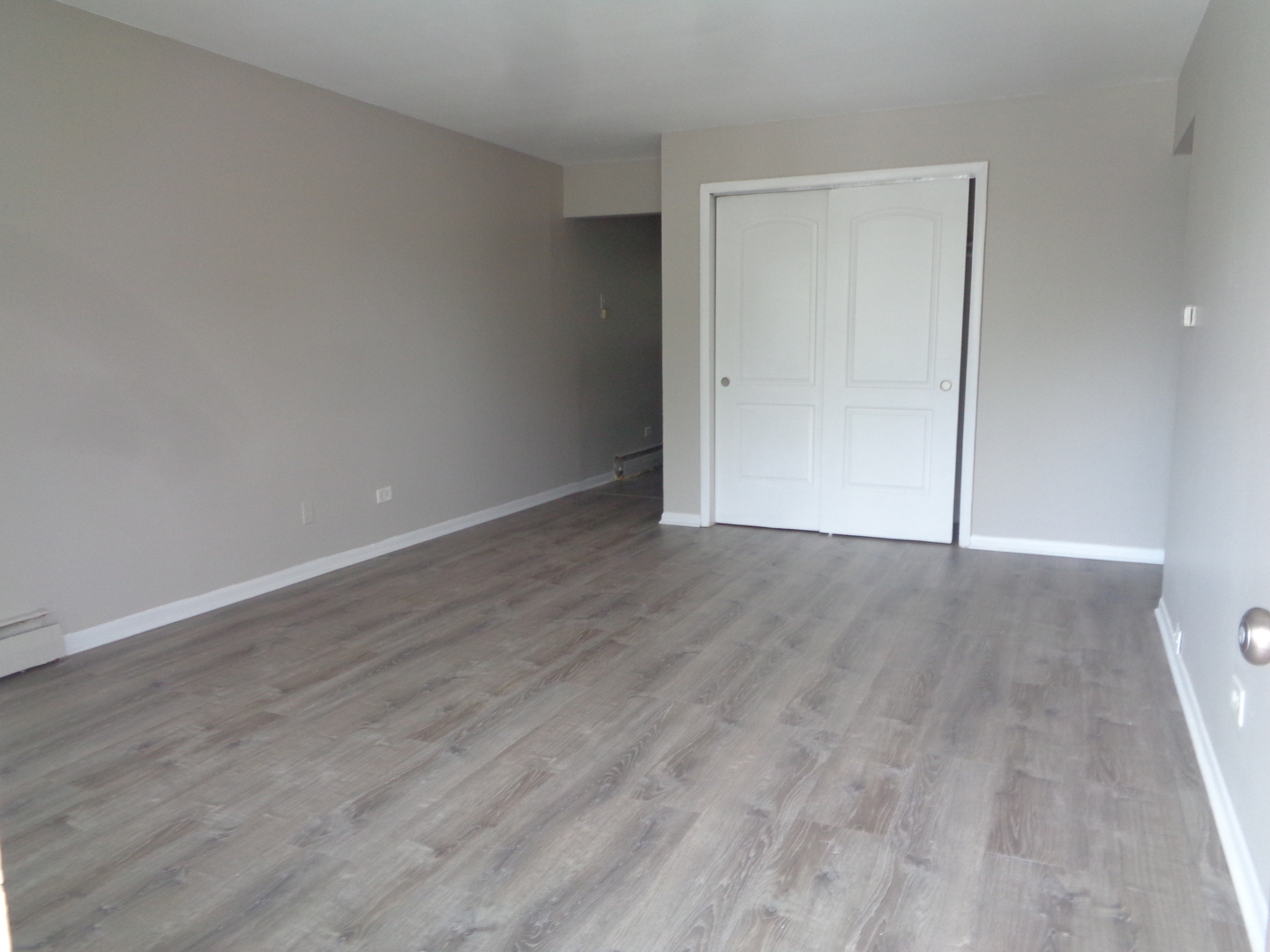 1340 North Main Street, Unit B11 Wheaton, IL 60187 - Photo 3 of 10 a view of an empty room with wooden floor