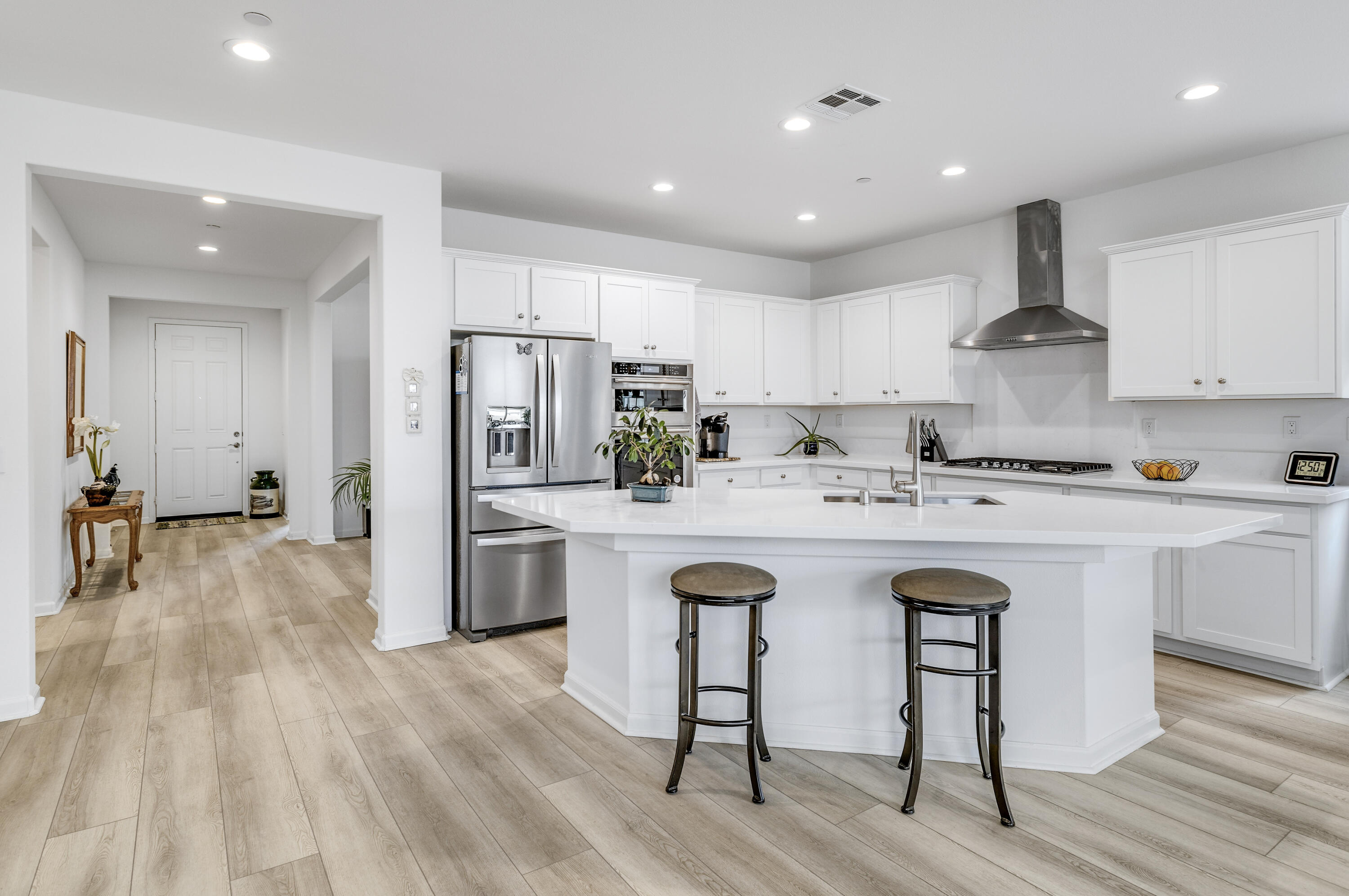 78804 Santa Rosa Way Palm Desert, CA 92211 - Photo 12 of 40 a kitchen with stainless steel appliances granite countertop a white cabinets and wooden floor