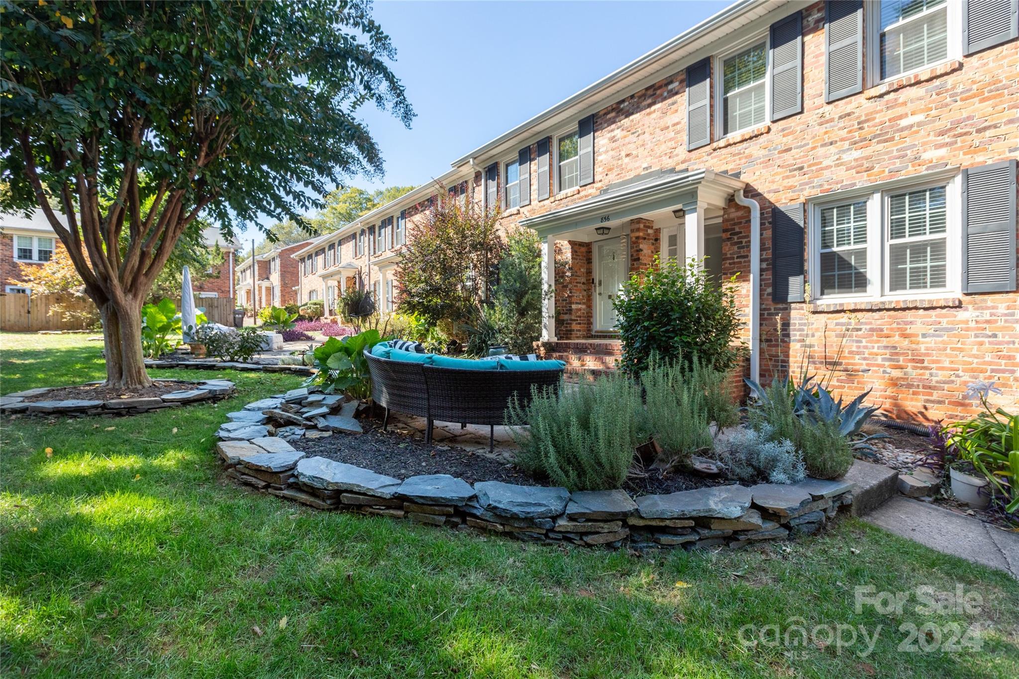 a view of a house with backyard sitting area and garden