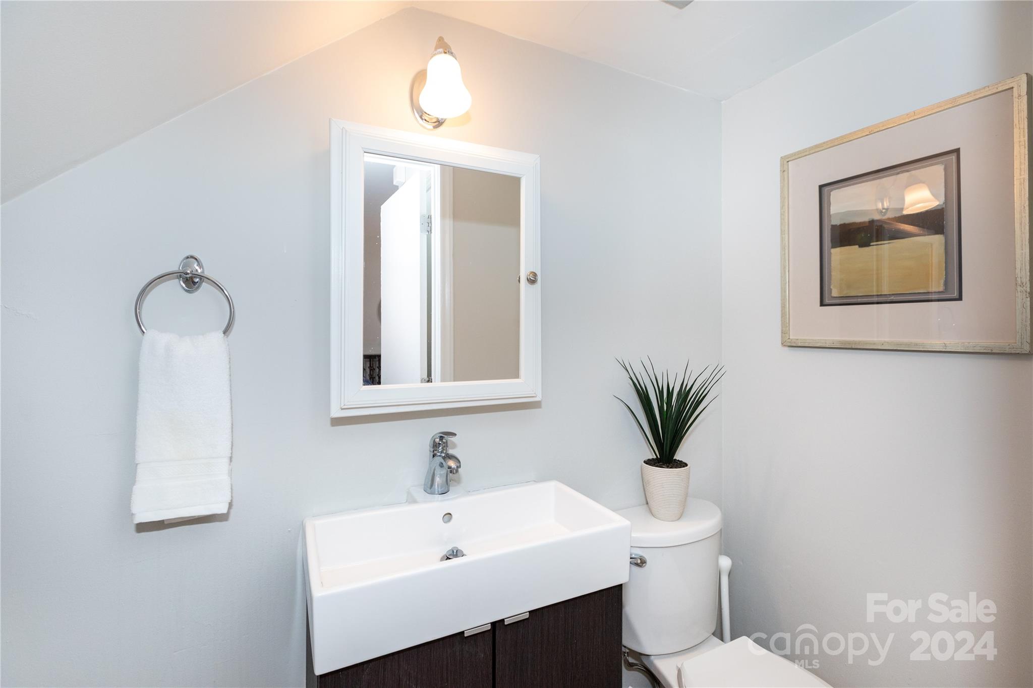856 McAlway Road, Unit B Charlotte, NC 28211 - Photo 12 of 25 a bathroom with a sink a toilet and mirror