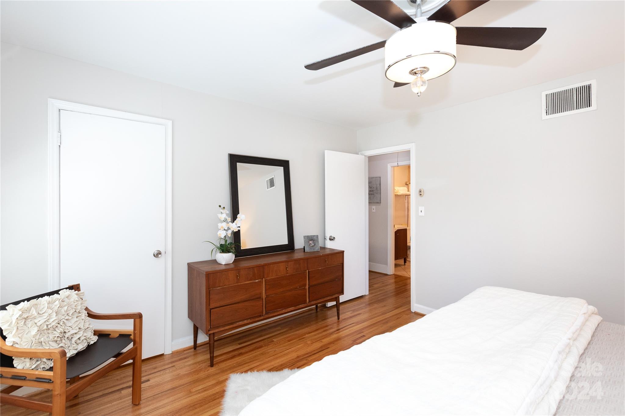 856 McAlway Road, Unit B Charlotte, NC 28211 - Photo 14 of 25 a bedroom with a bed and wooden floor