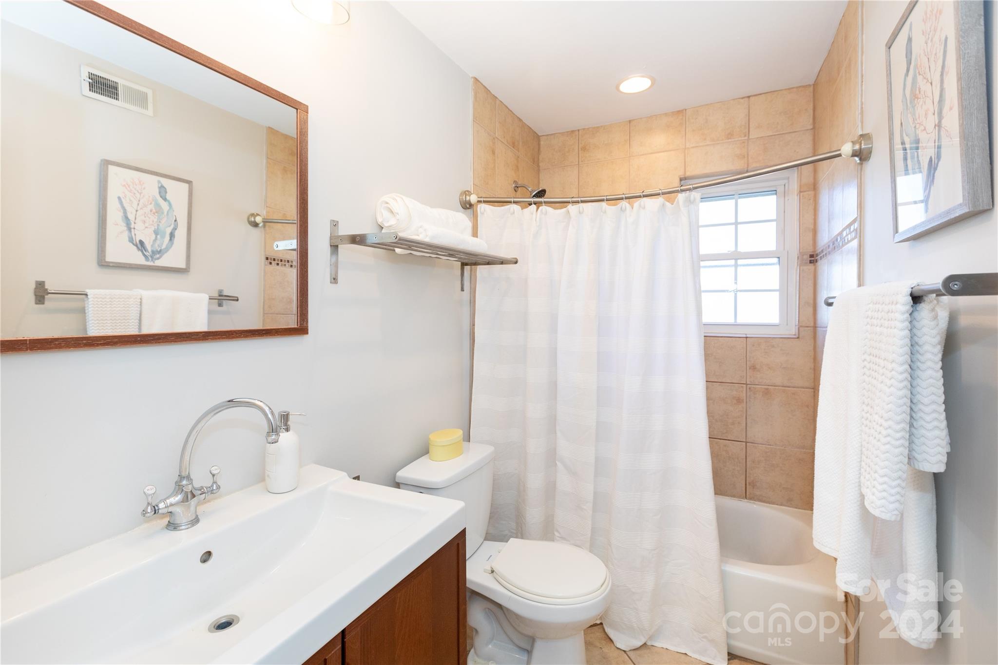 856 McAlway Road, Unit B Charlotte, NC 28211 - Photo 17 of 25 a bathroom with a sink toilet and shower