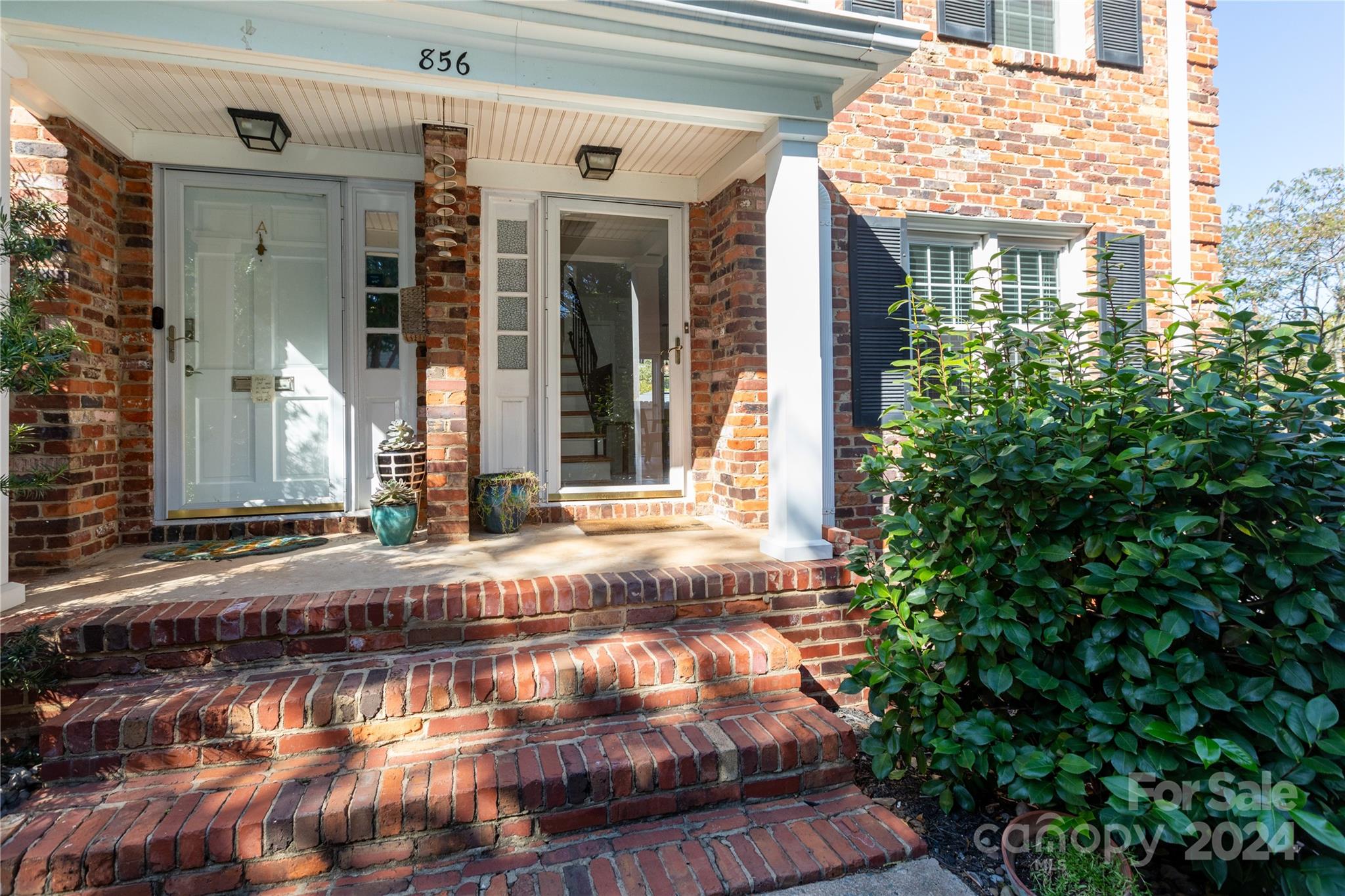 856 McAlway Road, Unit B Charlotte, NC 28211 - Photo 2 of 25 a view of a brick house with potted plants